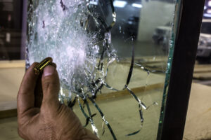 Bulletproof glass with hand and bullet